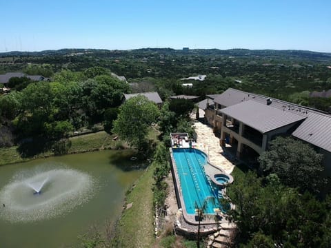 Five private acres! Two homes, three cabins, two pools, two hot tubs! One acre spring fed pond! Sleeps up to 25 guests! Relax and unwind in your own private oasis, just minutes from downtown Austin! (house 1)