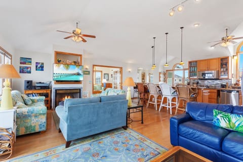 Relax in the beautiful Main Living Area with access to the Oceanfront Furnished Sun Deck. (Note: Fireplace is not for guest use)