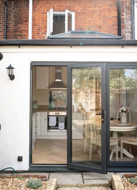 A modern and stylish kitchen, overlooking a pretty courtyard garden.