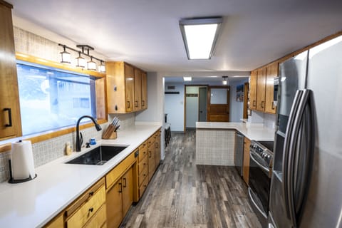 This beautiful, fully-stocked kitchen boasts sleek stainless steel appliances