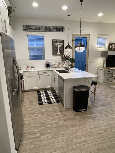 Kitchen w/ large island, full size appliances, equipped w/ everything you need.