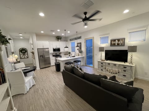 Living area with smart TV, comfy couch that pulls out to a queen sleeper