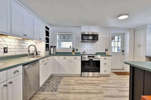 Large and open kitchen with fireplace and eat-in dining area.