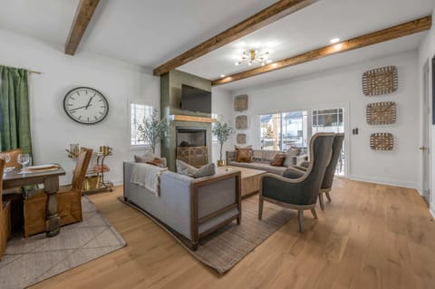 Sophisticated high-end living room with a striking fireplace centerpiece, designed to create a refined and inviting ambiance throughout your stay.