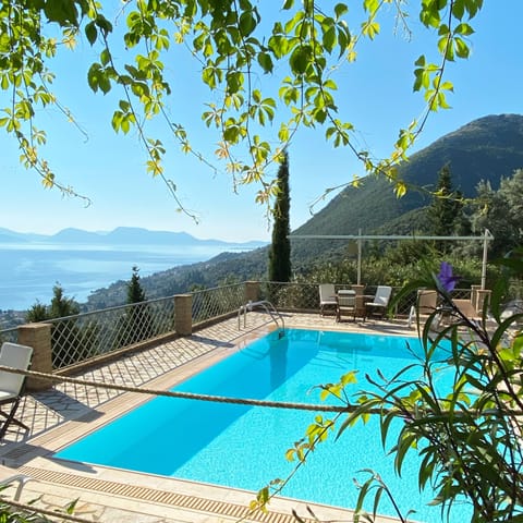 The pool area view from the wooden pergola where the outdoor lounge is located.