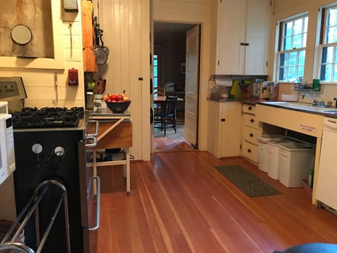 Basic, but highly stocked kitchen with view to dining room