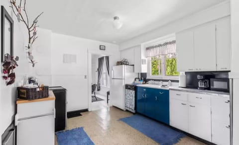 Kitchen with modern amenities. Oven, fridge, dishwasher, coffee pot, microwave.