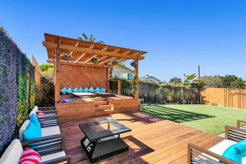 Experience the ultimate relaxation in your backyard oasis with this luxurious jacuzzi, complete with a projector for watching TV while soaking in the warm bubbles. Surrounded by lush greenery and a serene ambiance.