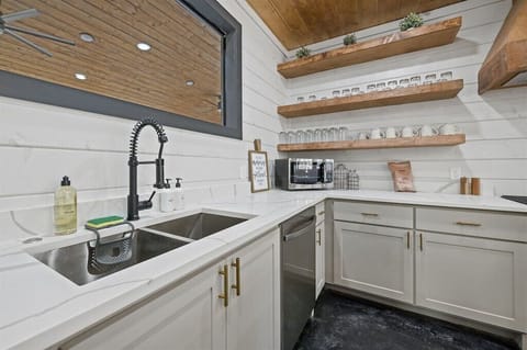 Kitchen: Sleek design meets rustic charm with open shelving and modern appliances!