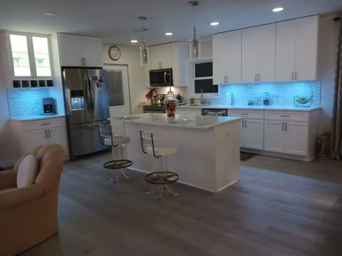 Newly renovated kitchen with open floor plan and accent lighting