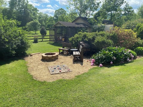 Fire pit with outdoor equipment shed behind.