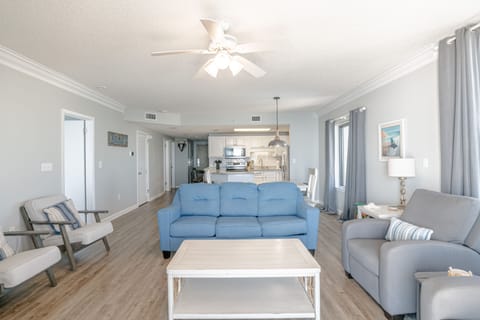 A shot looking from the balcony to through the dining area into the kitchen.