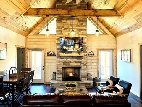 Cozy living room with dining area, 55” smart TV with cable, & gas log fireplace.