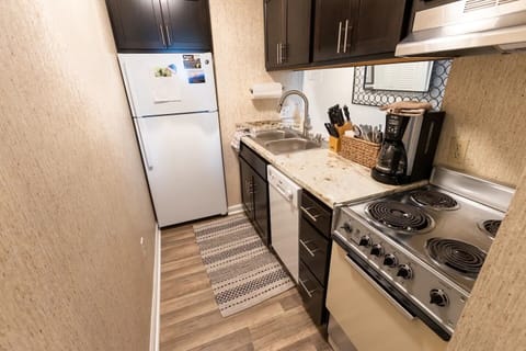 The kitchen has a full sized refrigerator, dishwasher, stove and oven. 