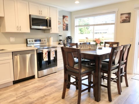 Next to the kitchen you'll find a countertop-height dining table and six chairs.