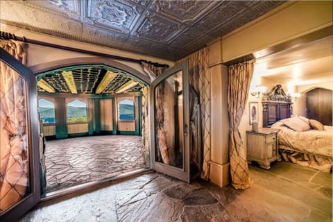 'The King's Suite' bedroom/living room looking out at the covered terrace