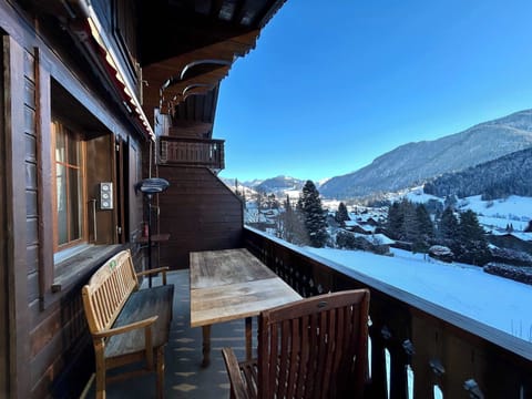 The sitting area on the balcony overlooks the snow-covered town.