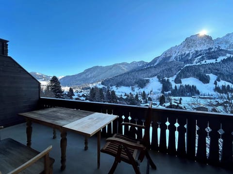 the spacious balcony with a panoramic alpine landscape view