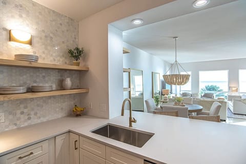 Kitchen with a full pantry and full-size washer and dryer combo.