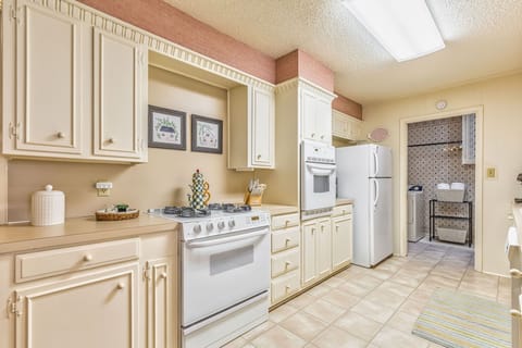 Fully stocked kitchen with modern appliances.