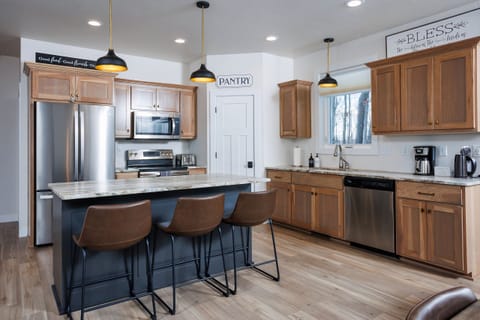 Large kitchen is fully stocked and includes seating at the island