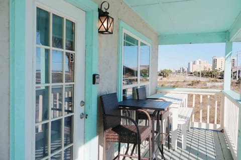 Balcony with view of water. Outside seating area. Picnic table.