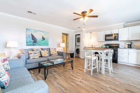 Aesthetically decorated living room. Top floor, with over looking balcony, connected to a full kitchen and dining room table.