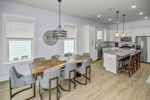 Dining table with seating for up to 8 guests, and an additional 3 seats at the kitchen island