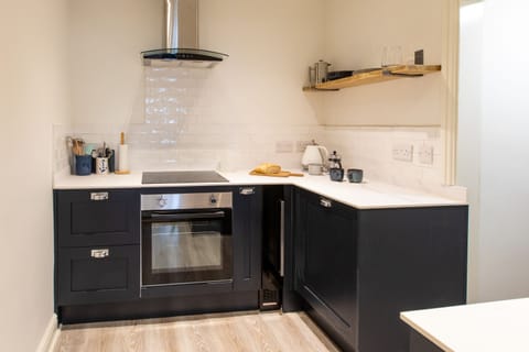 Kitchen with oven, wine chiller, fridge, dishwasher. Utility room to the side