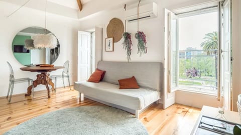 Bright main area with a sofa, dining table and balcony access! #bright #lovelystay