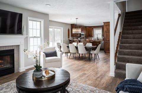 Unwind in the living room and take a peek into the kitchen to see dinner being crafted by the experts. Get cozy with a coffee or Sudoku around the coffee table - complete with stools for extra seating, game night fun, or just somewhere to kick back.