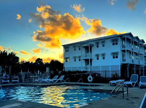 Waterfront resort pool at sunset