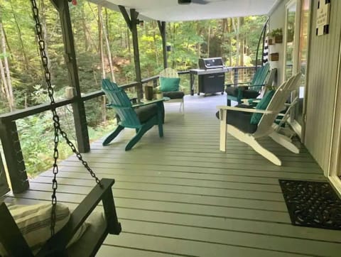 Back covered porch with swing and Adirondack chairs. Gas grill is provided. 