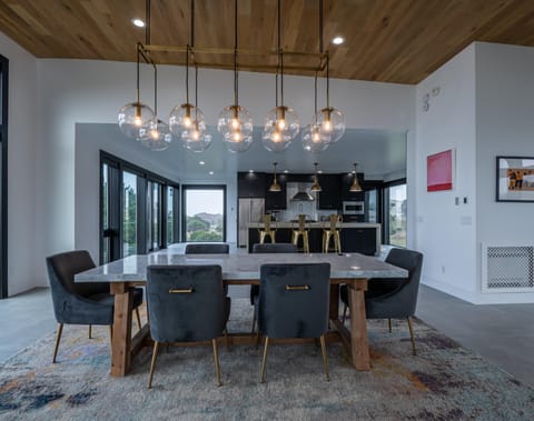 Table with seating for 6 and additional seating at nearby kitchen bar