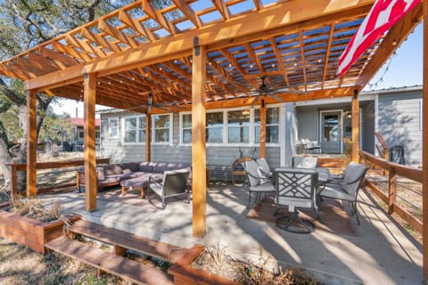 Back patio with a sectional couch and table and chairs