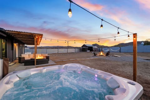 Soak beneath the string lights while two fire features and a colorful desert sunset set the scene.