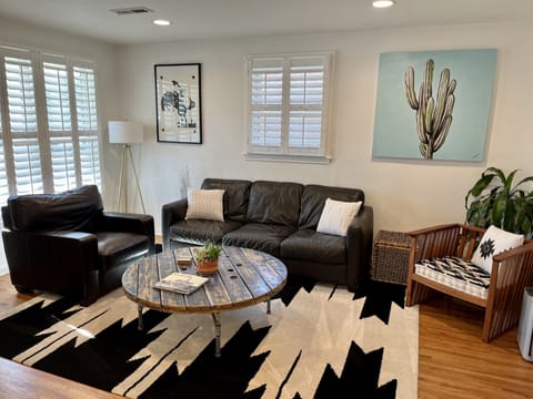The living room includes a soft Italian leather couch and chair.