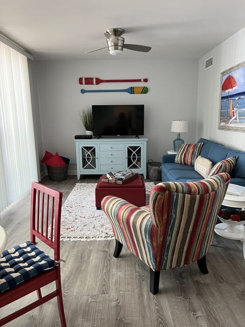 Living area with cable TV, sleeper sofa, books, and games.