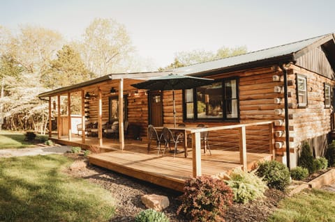 Enjoy an authentic log cabin nestled on 10 secluded acres with plenty of space to relax and enjoy nature.