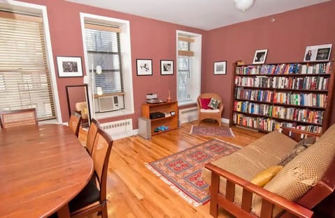 Living room with futon and dining room table.