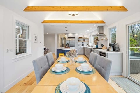 Beamed dining room with open view to kitchen