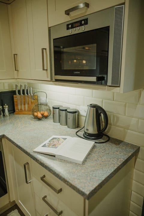 Ground floor: Open plan kitchen with oven, 4 ring hob, fridge, freezer, microwave & dishwasher