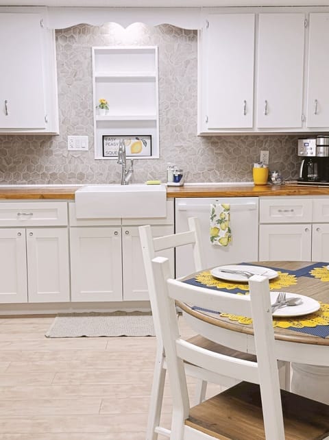 Gorgeous farmhouse sink and chrome faucet make the kitchen extra luxurious