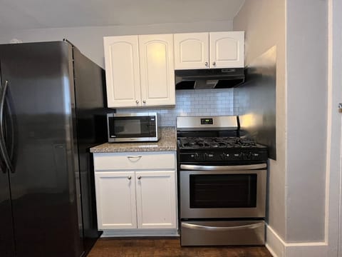 Microwave and gas stove make dining-in easy.