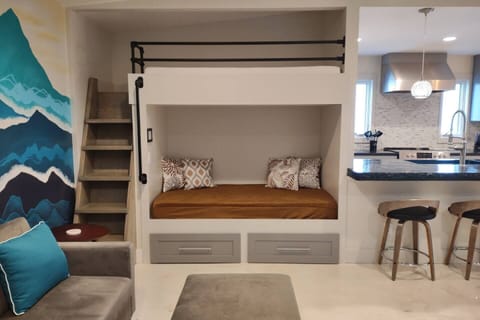 Built-In Twin Bunks with Memory Foam Mattresses.  The lower bunk is covered for sitting and lounging as part of the living space.  Linens are provided for both bunks so they can be used for sleeping space