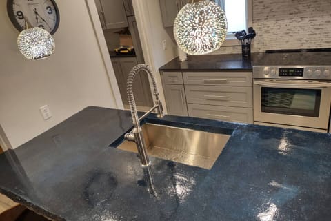 Concrete stained bar top with sink and 4 bar stools