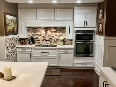 The kitchen appliances include an electric stove, oven/ convection microwave.
