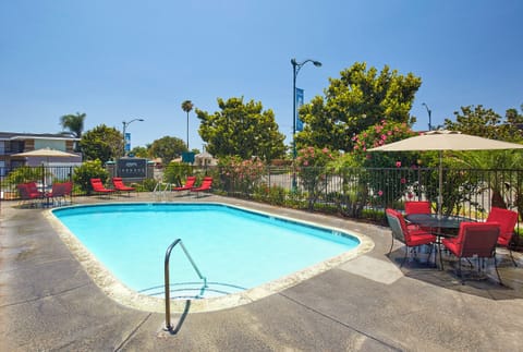 Unwind poolside under sunny skies with comfy loungers nearby.