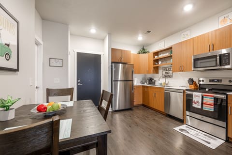 Sleek kitchen w/ stainless steel appliances, granite counters & plenty of space to cook.