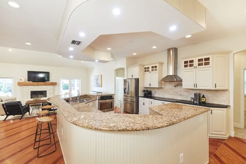 The huge kitchen island has seating for 6 at the bar, double sinks, double ovens and dishwasher
